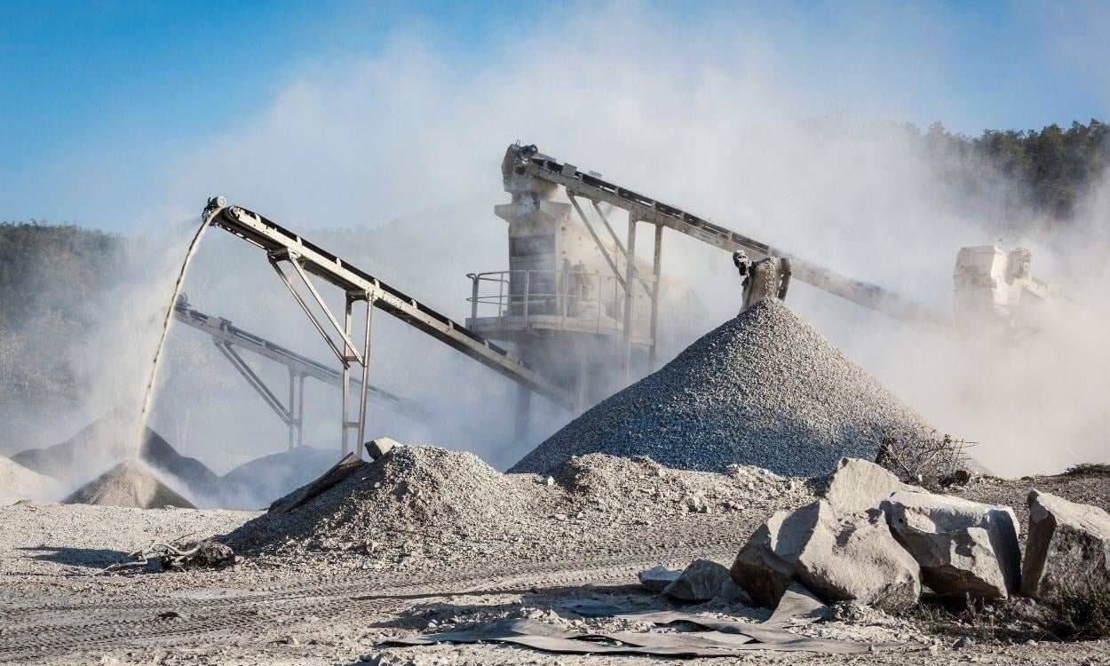 Industrial rock crushing and gravel production site with conveyor belts