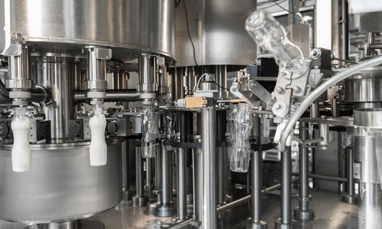 Automated bottling equipment in industrial packaging facility